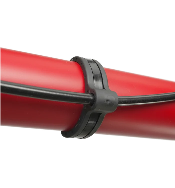 Flexroute TPV rubber line clamp and cable tie guide securing tubing and wire harnesses.