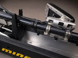 Black rubber line clamp securing electrical wiring to metallic boat framing and brackets.